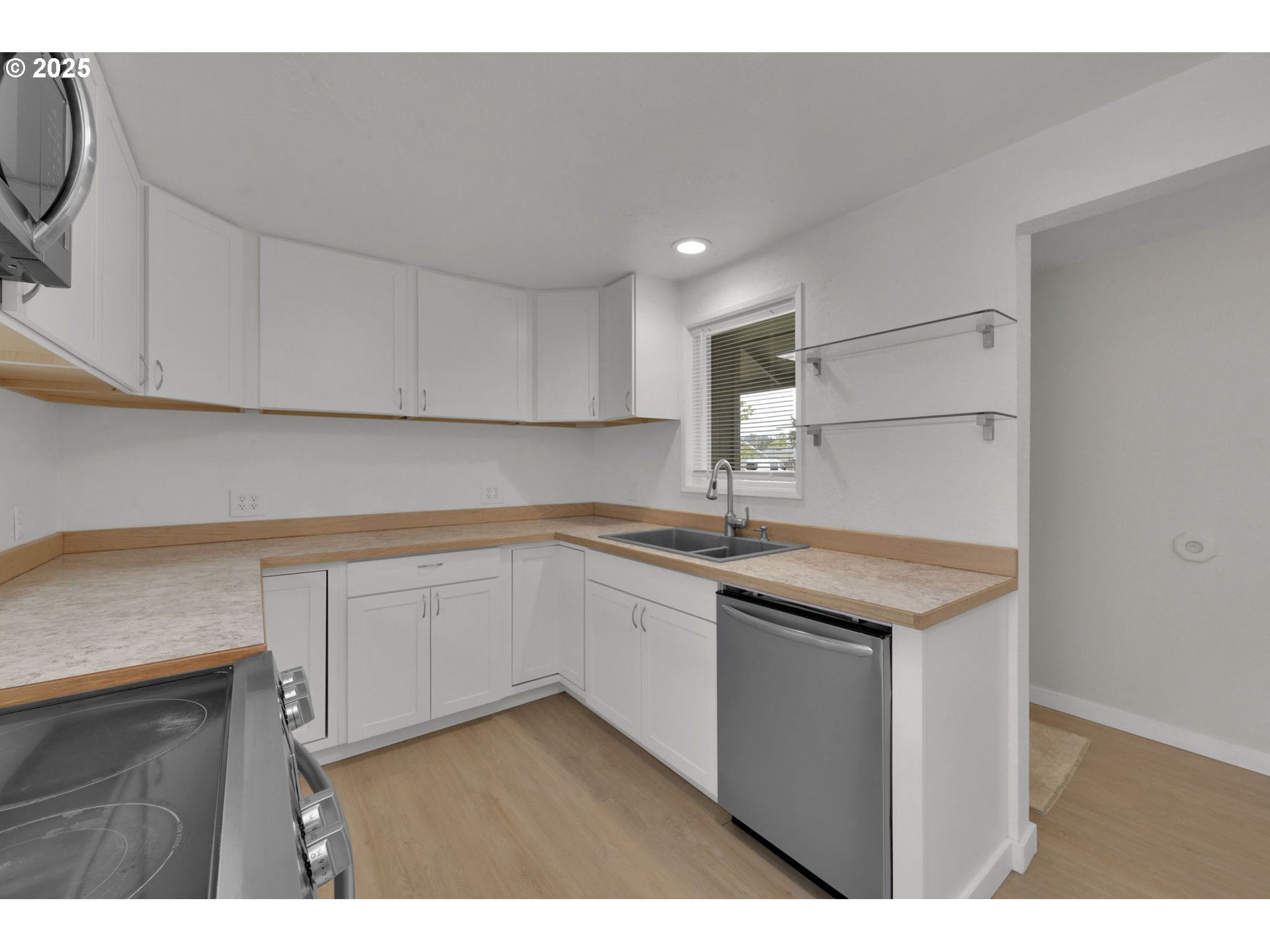 696 Island Street Springfield, OR 97477 - Photo 6 of 27 a kitchen with a sink cabinets and wooden floor