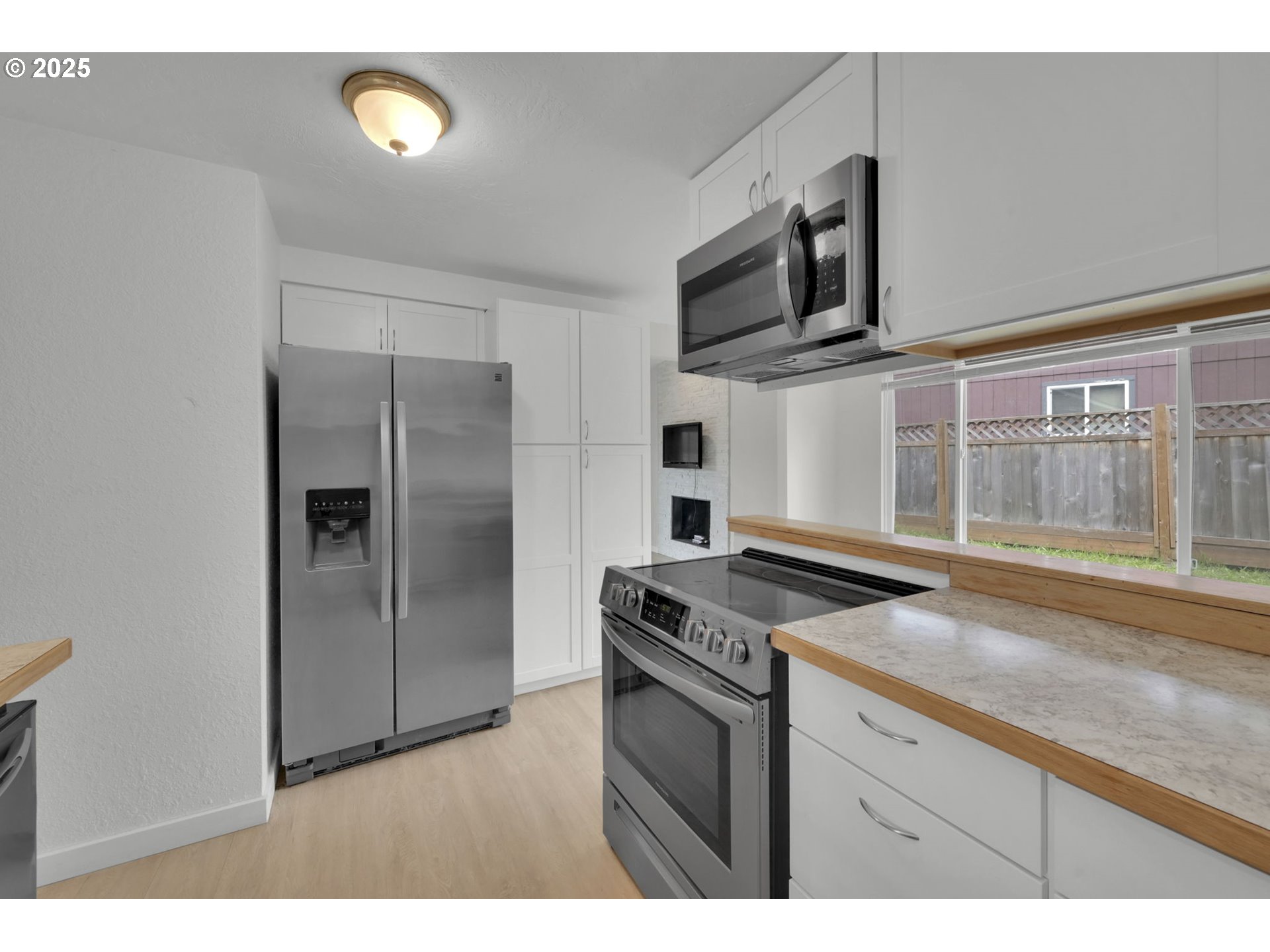 696 Island Street Springfield, OR 97477 - Photo 8 of 27 a kitchen with stainless steel appliances granite countertop a refrigerator and a sink