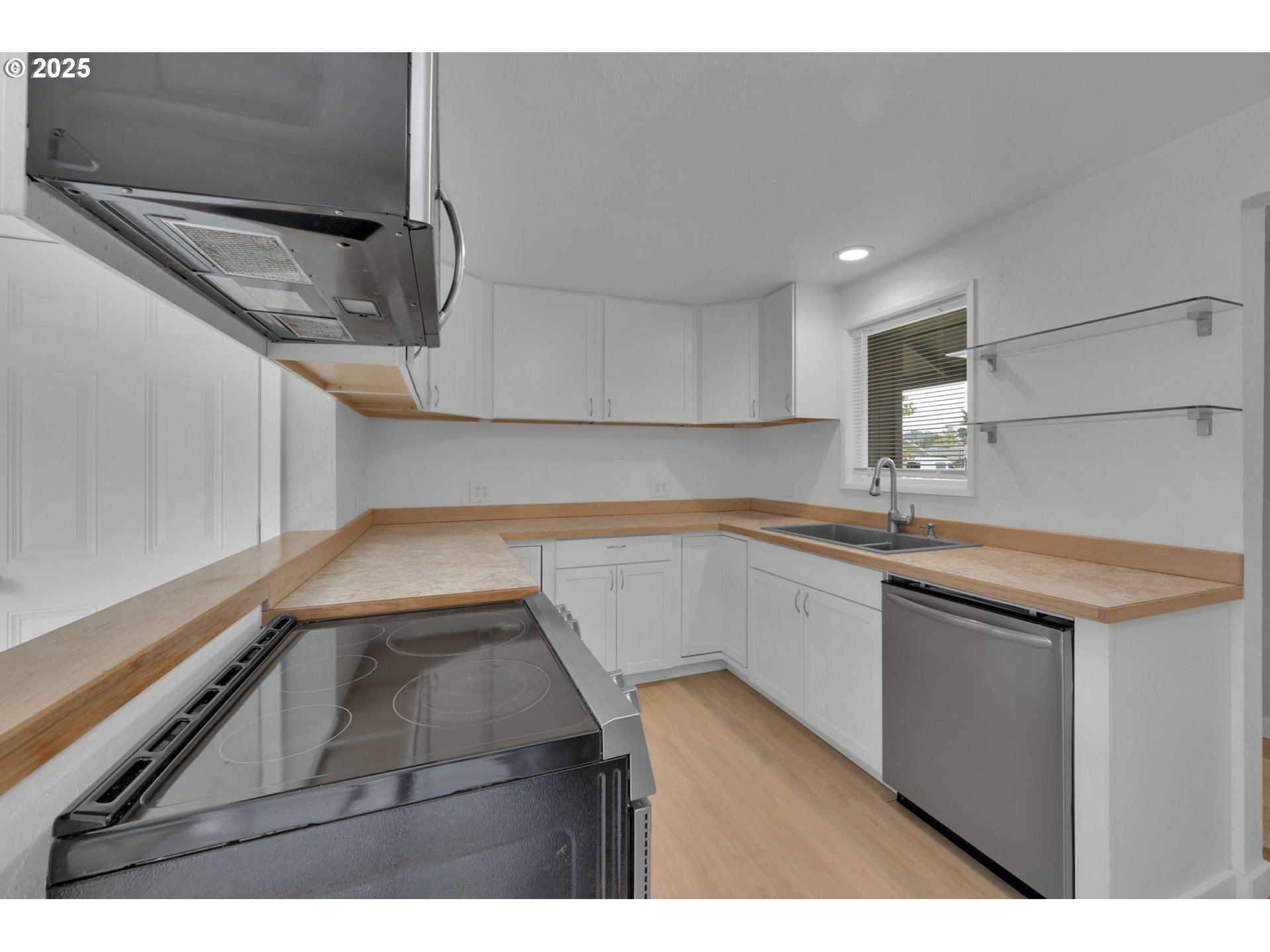 696 Island Street Springfield, OR 97477 - Photo 9 of 27 a kitchen with a sink and a refrigerator