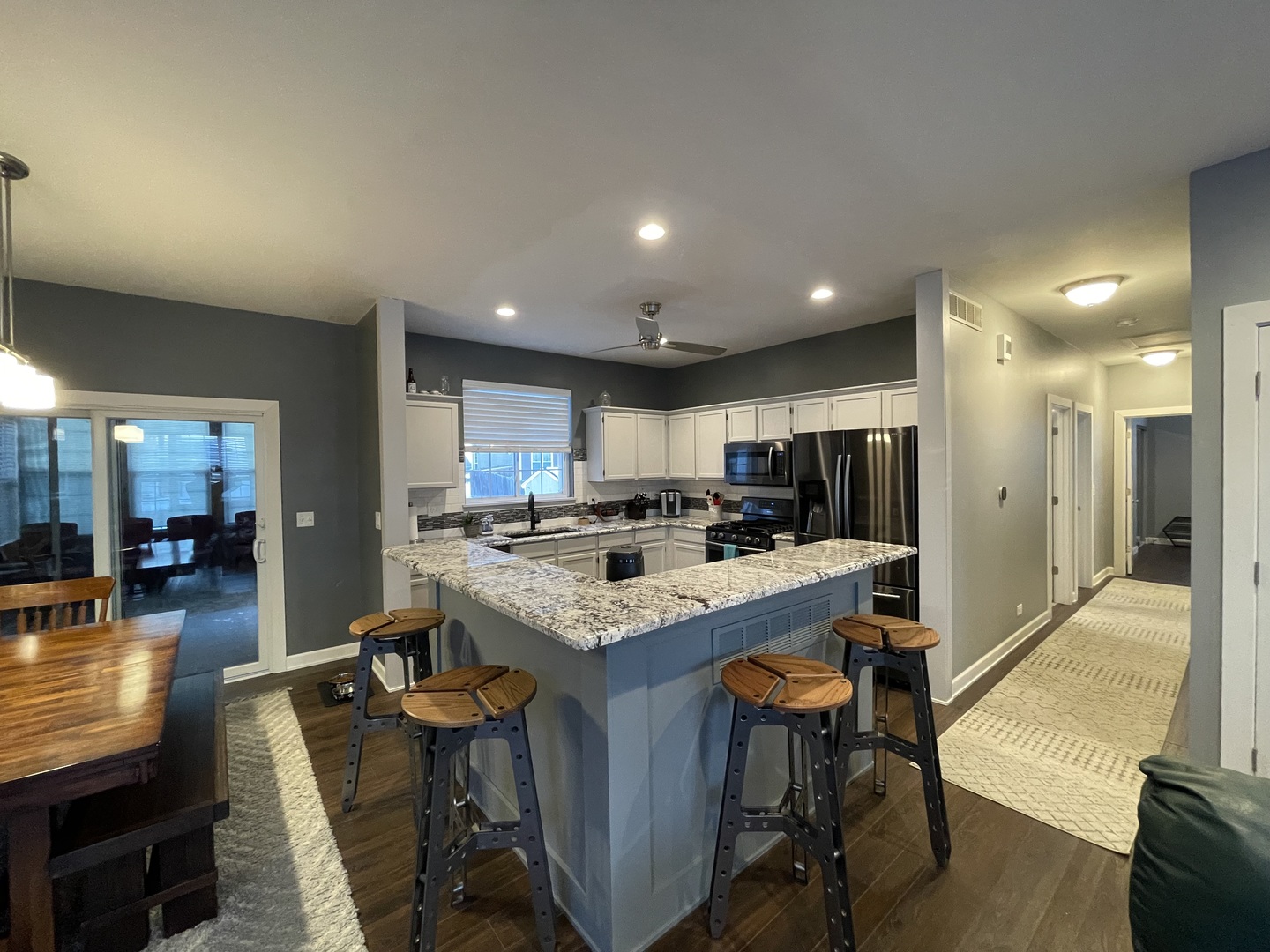 1687 Kautz Road Aurora, IL 60504 - Photo 8 of 23 a kitchen with stainless steel appliances kitchen island granite countertop a table chairs sink and cabinets