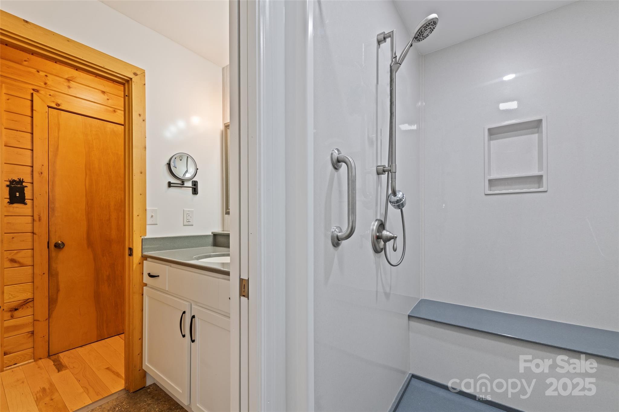 4231 Bald Creek Road Clyde, NC 28721 - Photo 11 of 23 a bathroom with a granite countertop sink a mirror and shower