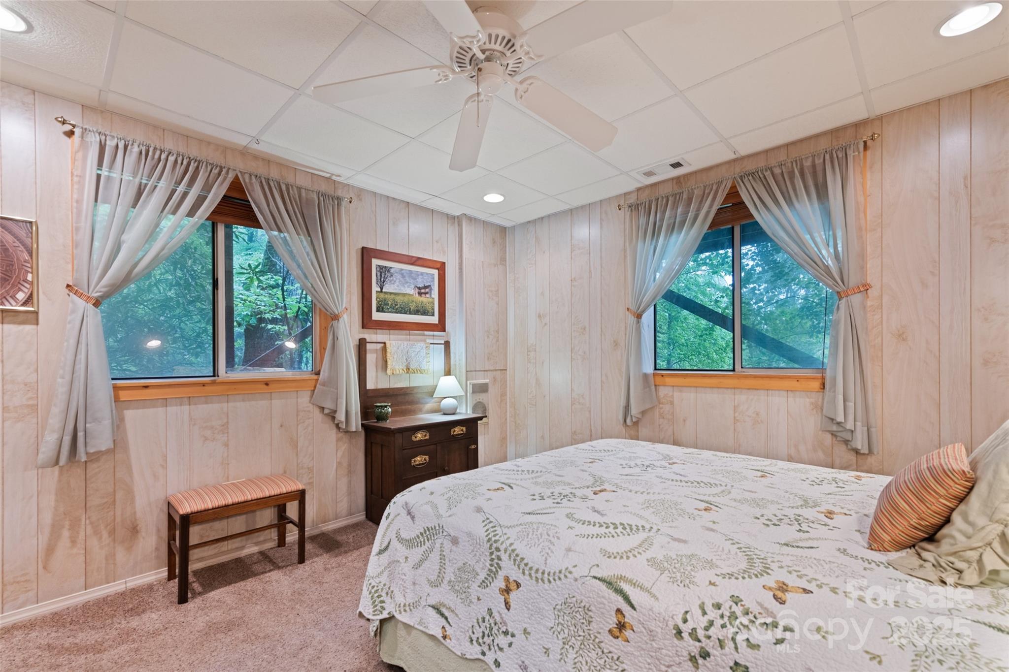 4231 Bald Creek Road Clyde, NC 28721 - Photo 14 of 23 a bedroom with a bed and a dresser next to a window