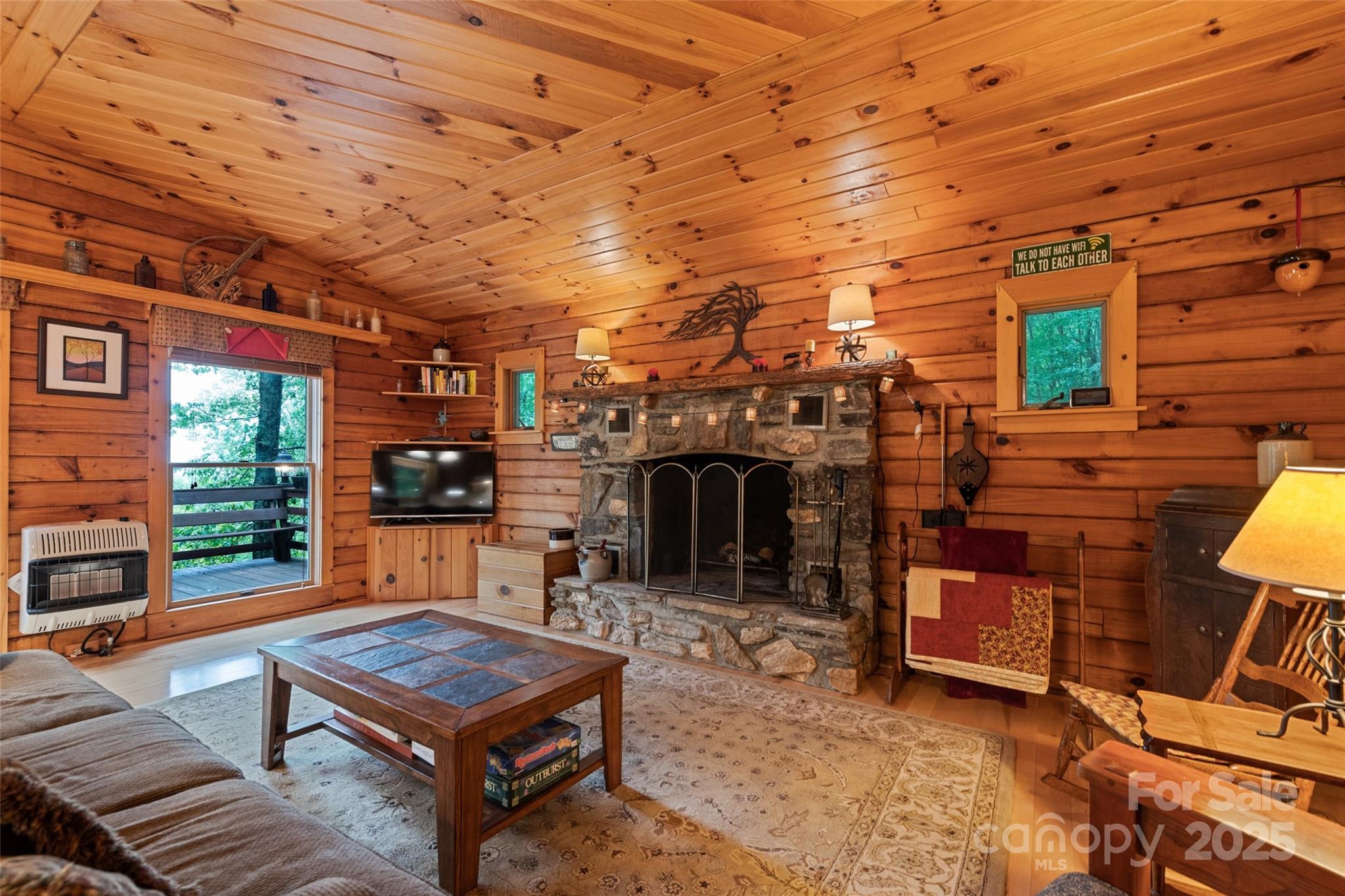 4231 Bald Creek Road Clyde, NC 28721 - Photo 5 of 23 a living room with furniture a fireplace and a table