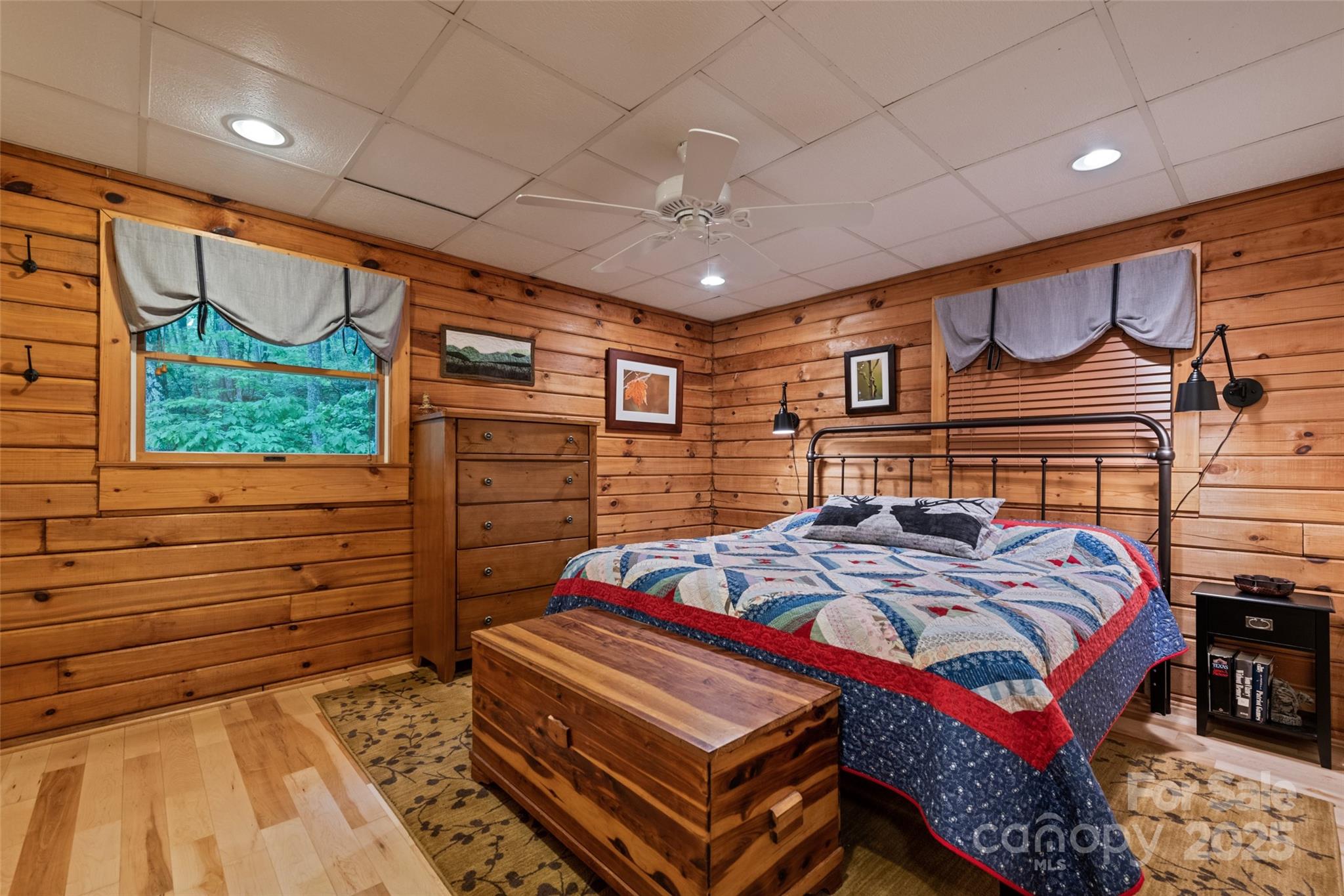 4231 Bald Creek Road Clyde, NC 28721 - Photo 8 of 23 a bedroom with a bed a dresser and a large window