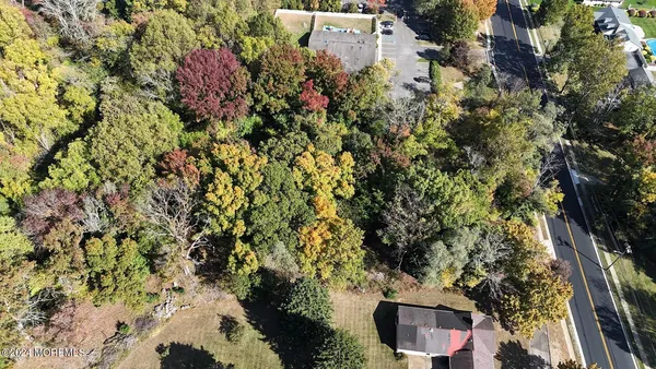 an aerial view of residential house with parking and yard