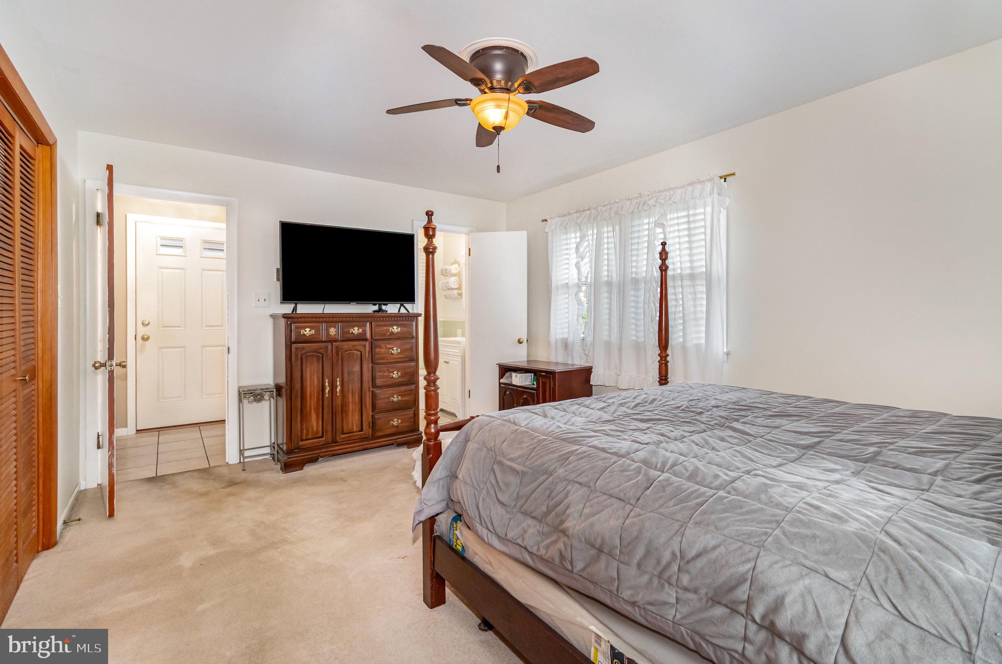 12 Shady Road Camp Hill, PA 17011 - Photo 17 of 32 a spacious bedroom with a bed and a flat screen tv