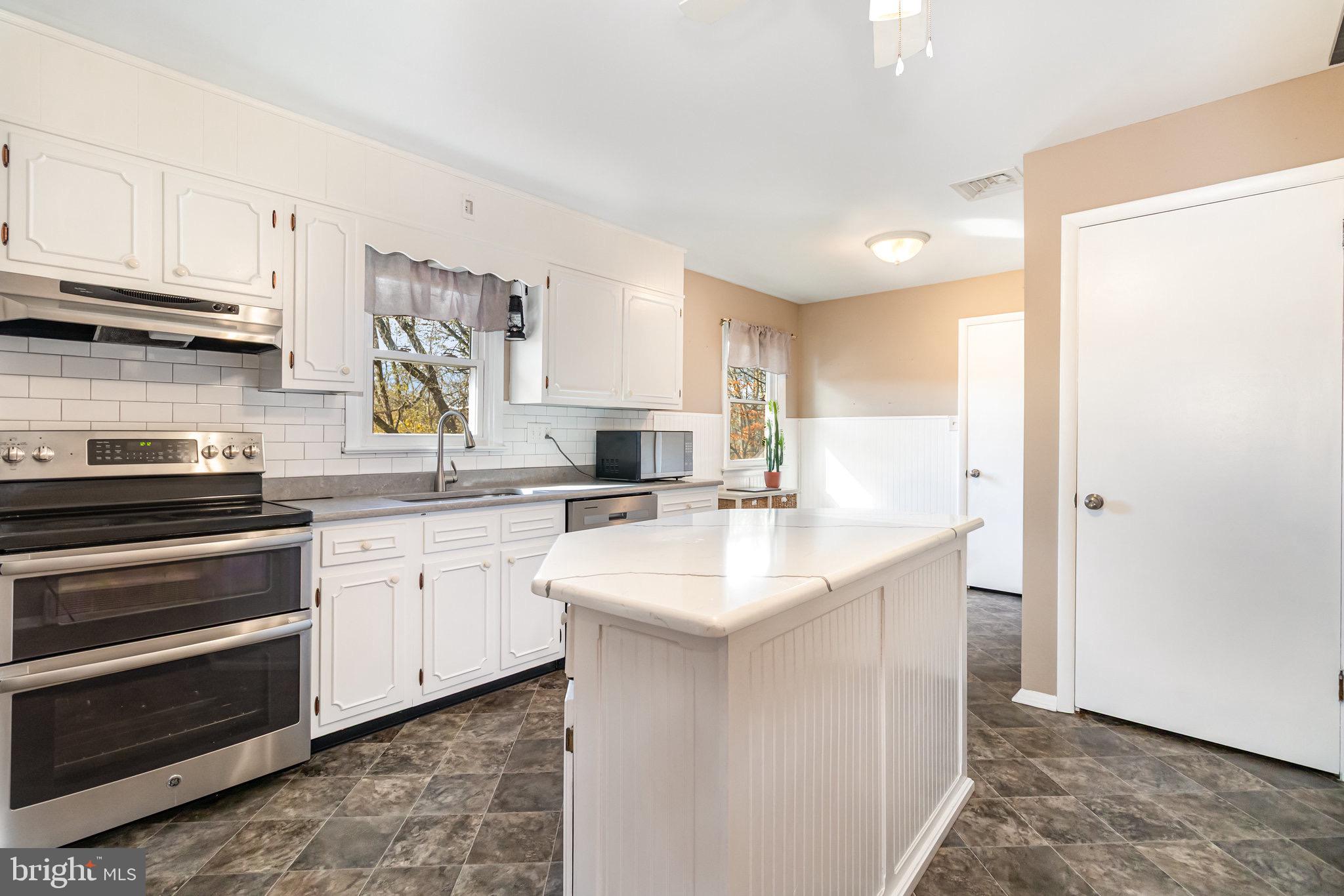 12 Shady Road Camp Hill, PA 17011 - Photo 10 of 32 a kitchen with stainless steel appliances granite countertop a sink stove and refrigerator