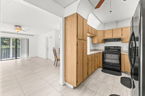a kitchen with stainless steel appliances a refrigerator and cabinets