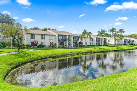 a view of a lake with a house in the background