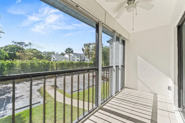 a view of a balcony with wooden floor