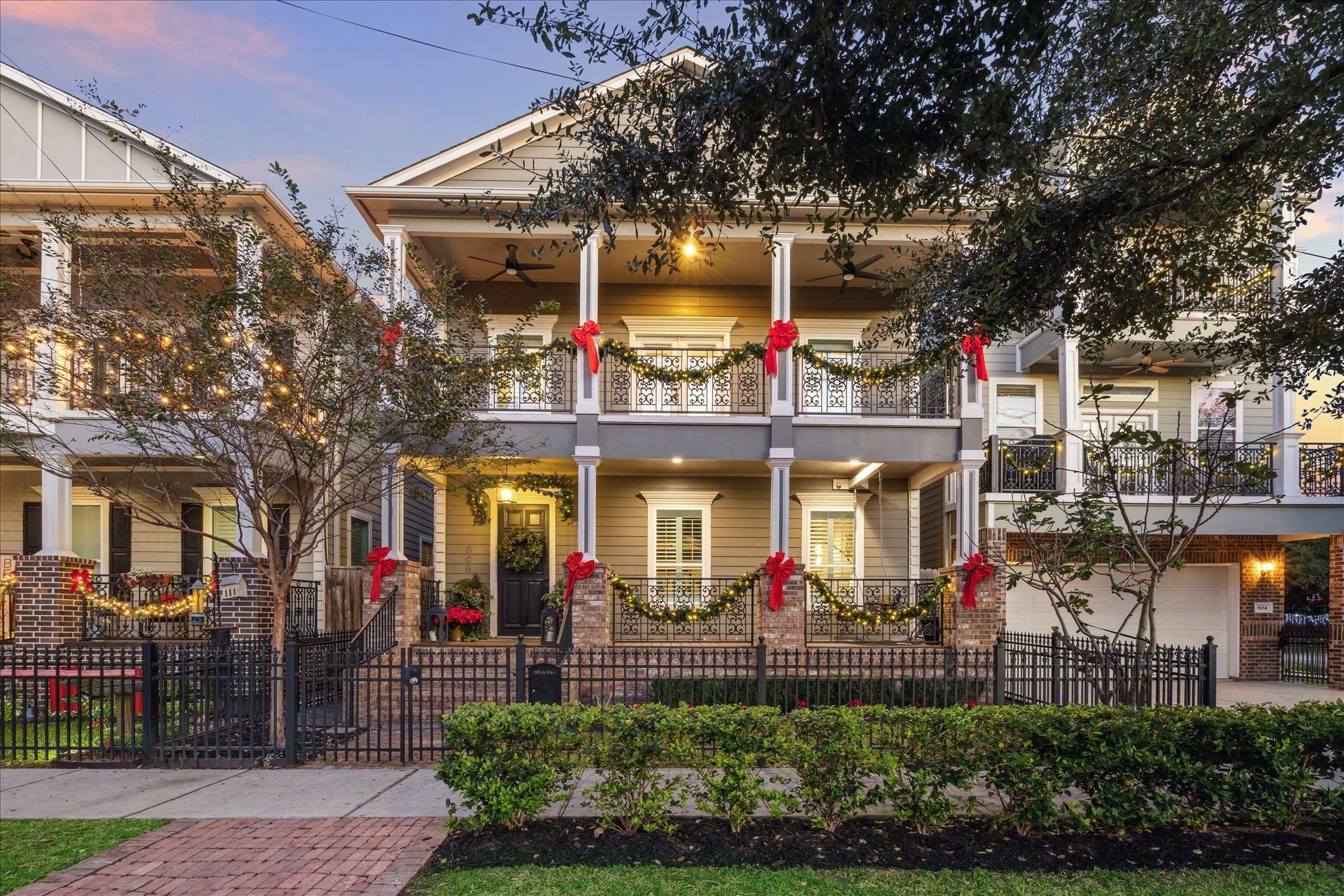 This charming two-story home features a welcoming front porch and balcony