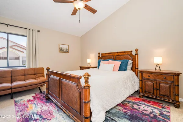 a bedroom with a bed and a couch