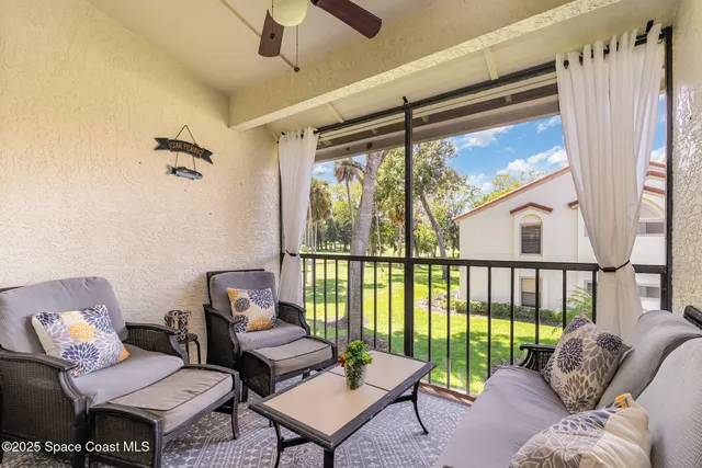 a view of a house with swimming pool and sitting area
