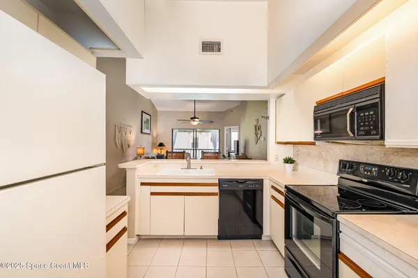 a kitchen with a sink and stainless steel appliances