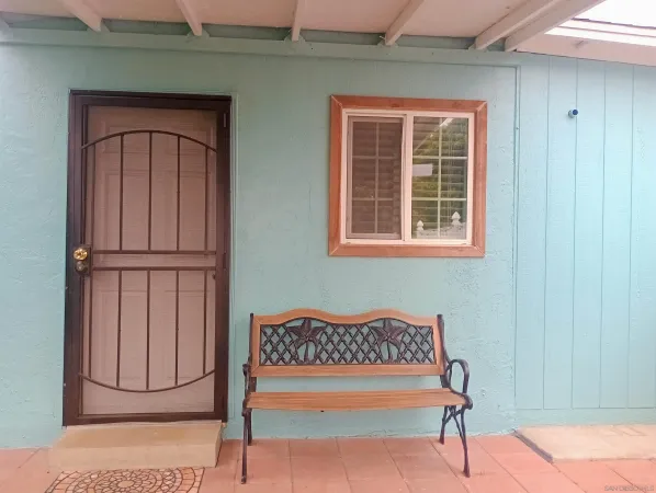 a view of a kitchen with furniture and a window