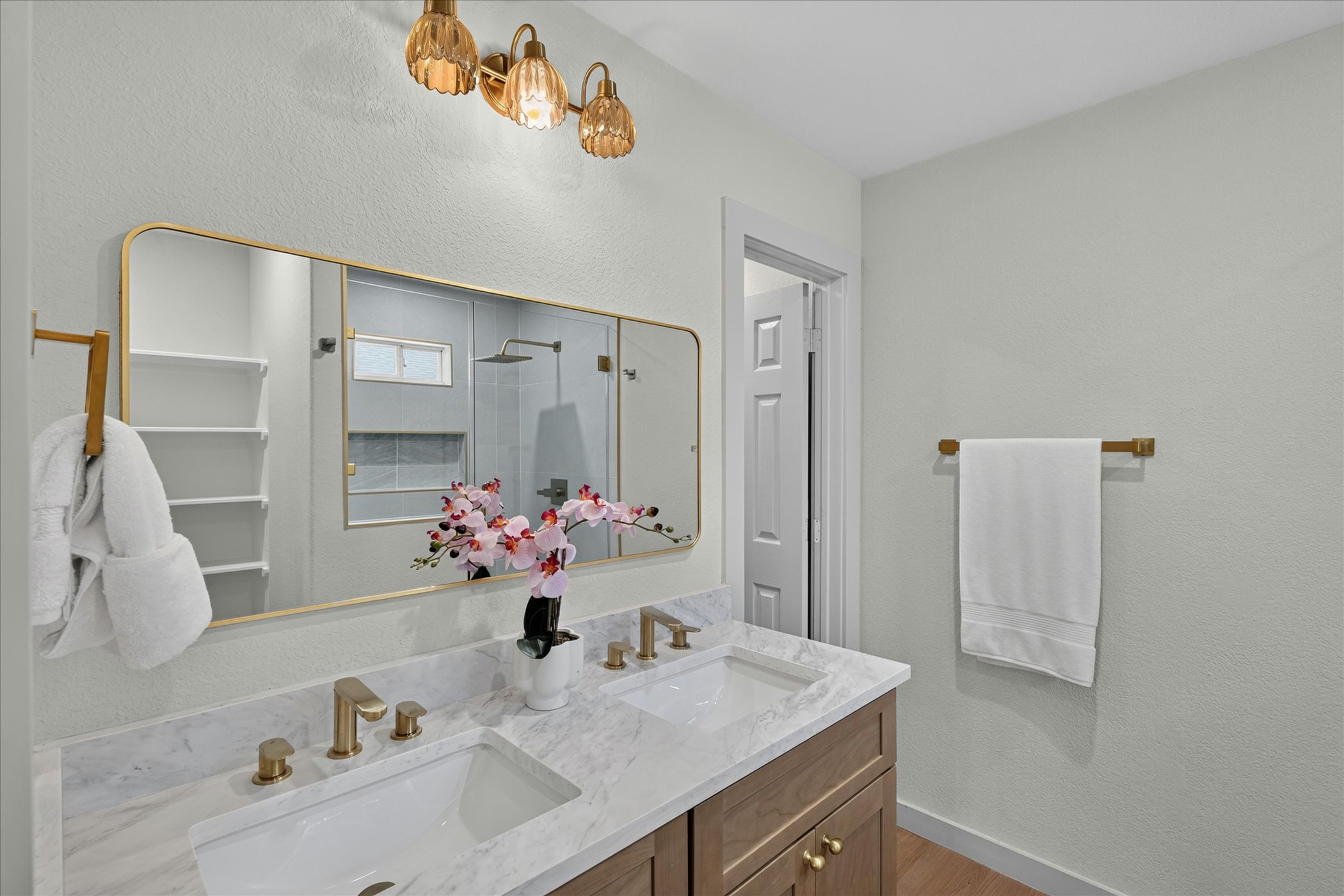 258 Pine View Loop Bastrop, TX 78602 - Photo 30 of 40 Refined primary bath features a dual vanity with marble counters and sleek gold fixtures.