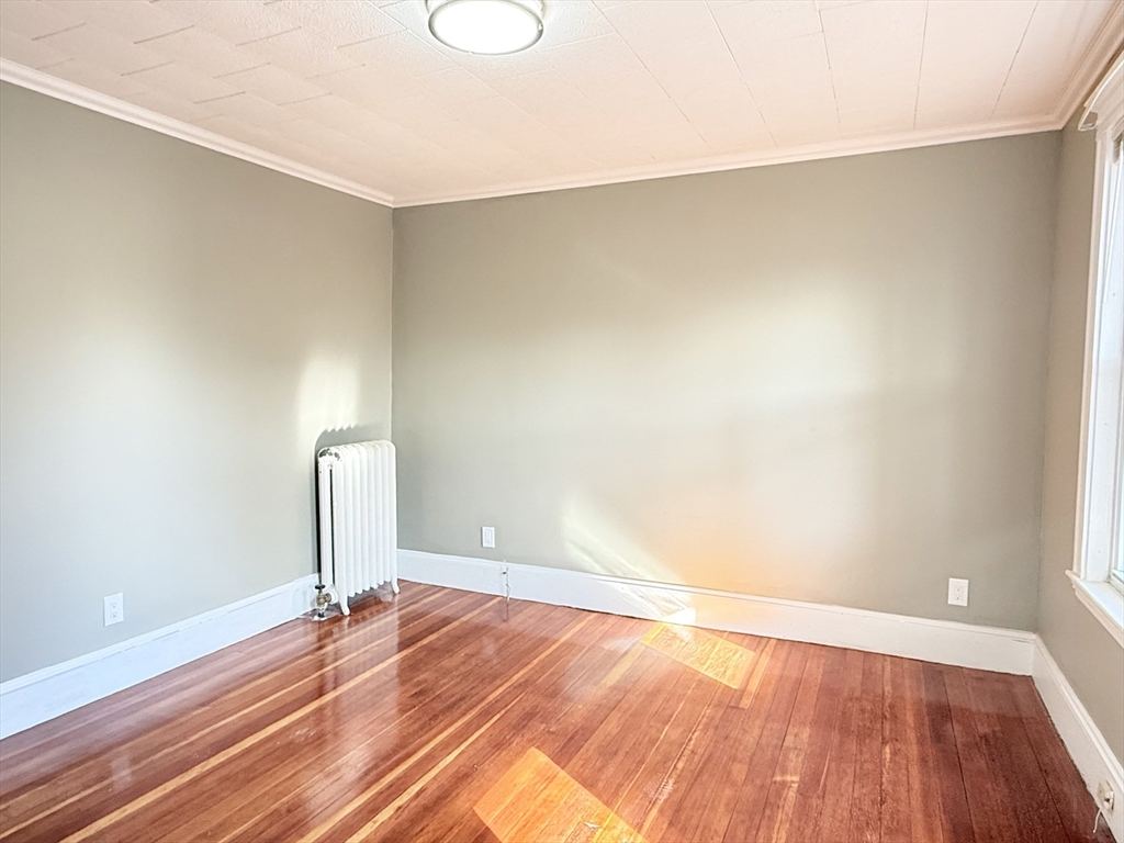 21 High Street, Unit 1 Somerville, MA 02144 - Photo 12 of 14 a view of empty room with wooden floor