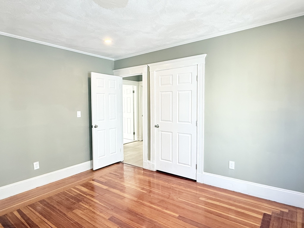 21 High Street, Unit 1 Somerville, MA 02144 - Photo 9 of 14 a view of an empty room and wooden floor