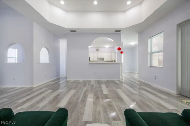 a living room with furniture and a chandelier