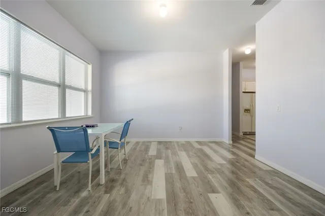 a view of a room with wooden floor and a window