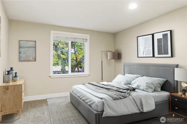 a bedroom with a bed and a window