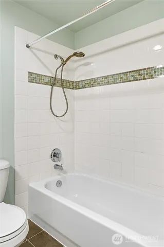 a bathroom with a shower and a bath tub