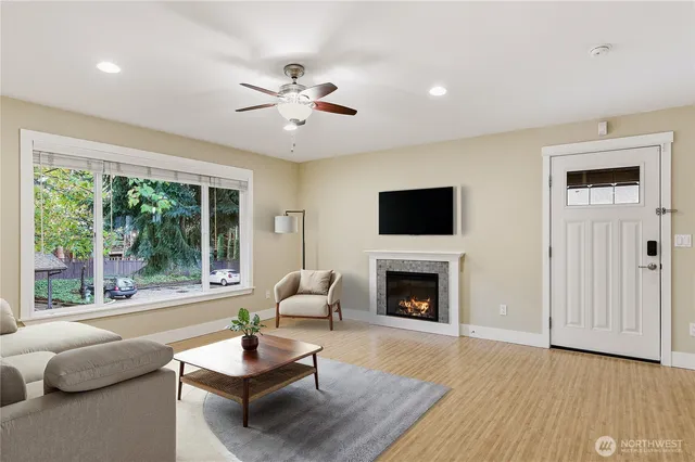 a living room with furniture fireplace and a large window