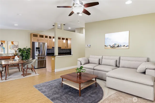 a living room with furniture a rug and a chandelier
