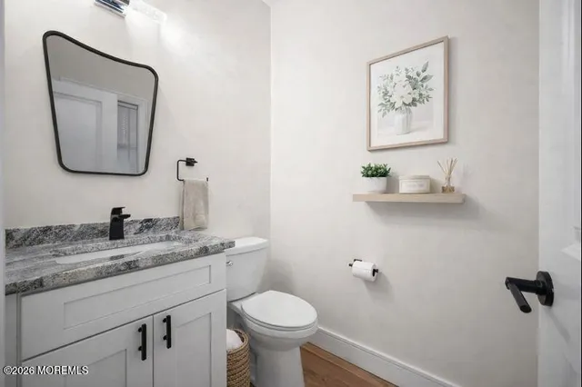 a kitchen with stainless steel appliances granite countertop a stove top oven a sink dishwasher and a fireplace with wooden floor