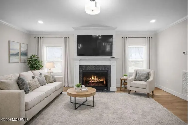 a kitchen with stainless steel appliances granite countertop a dining table chairs refrigerator and sink