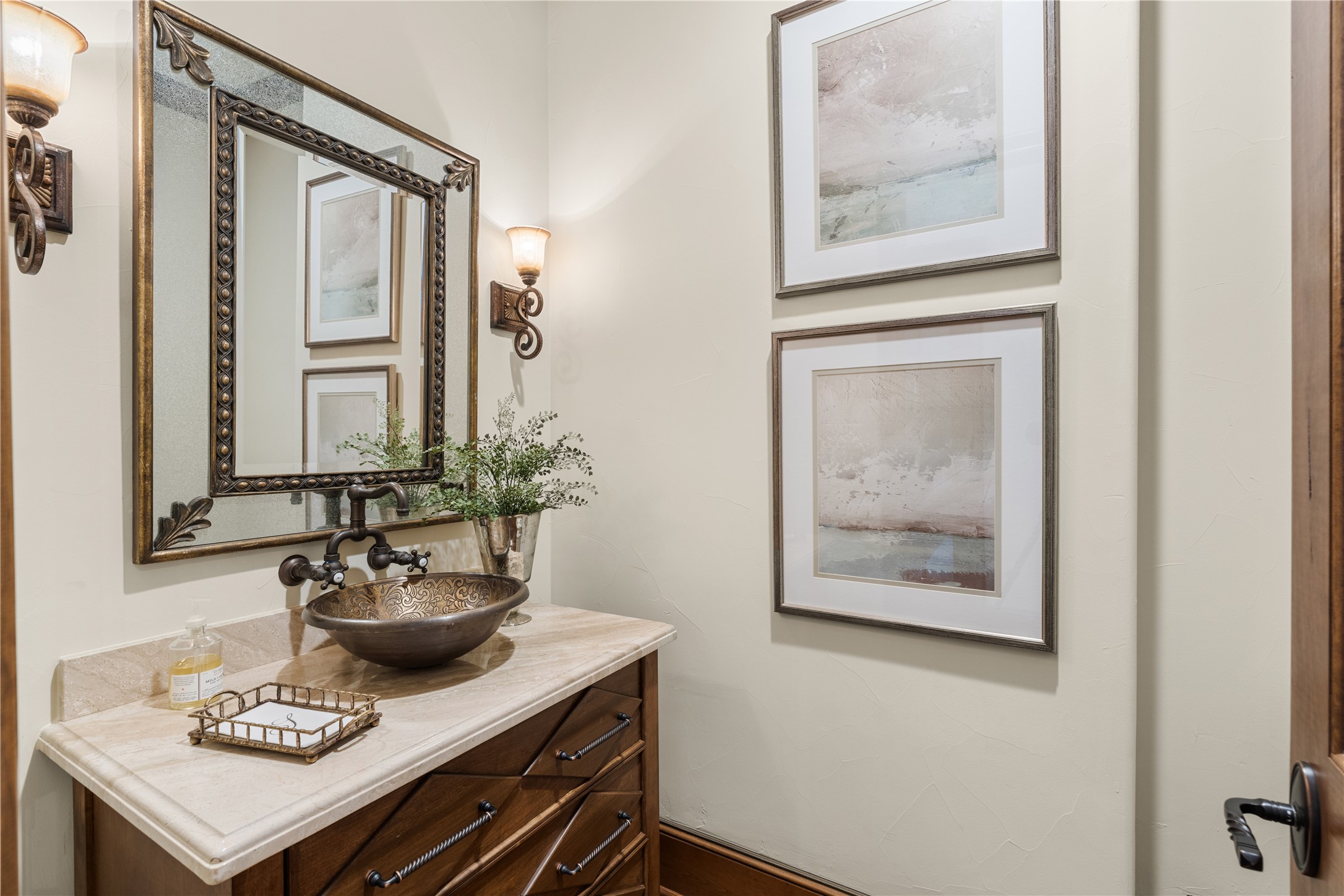 12349 Longmire Trace Conroe, TX 77304 - Photo 12 of 48 Stylish powder bath featuring a vessel sink, stone countertop, and warm wall sconces.