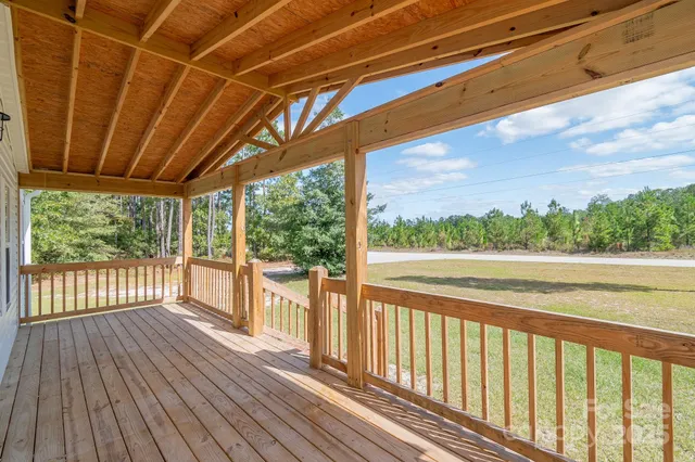a view of a balcony with wooden floor