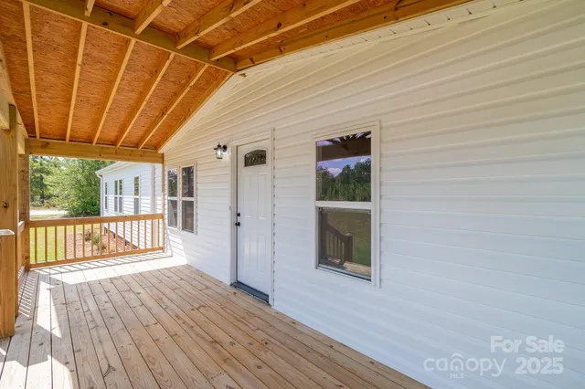 a view of a balcony with wooden floor