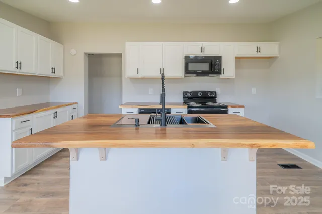 a kitchen with a sink a stove and cabinets