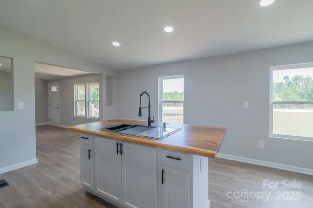 a hallway with sink and mirror