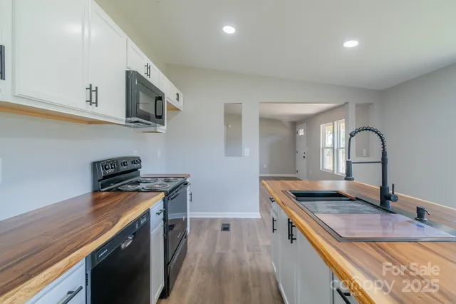 a view of kitchen with cabinets