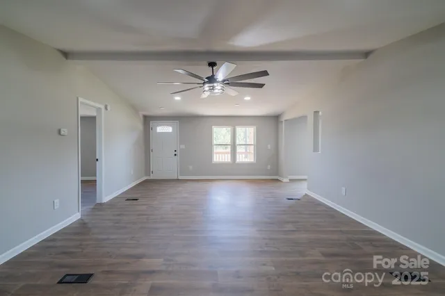 wooden floor in an empty room with a fireplace