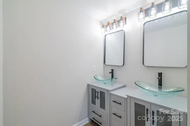 a bathroom with mirror and sink