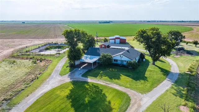 a view of a city with lawn chairs under an umbrella
