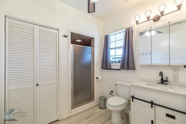 a bathroom with a toilet sink and shower