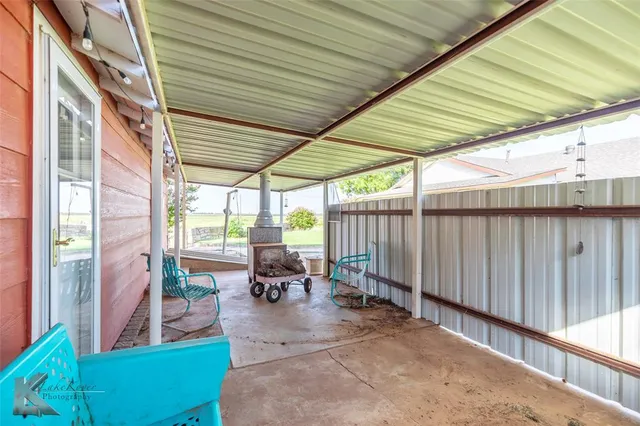 deck with table and chairs and wooden fence