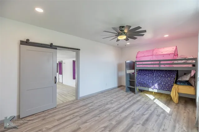 a bed room with a bed and a chandelier