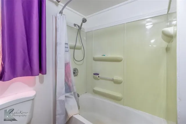a bathroom with a shower curtain and a bathtub