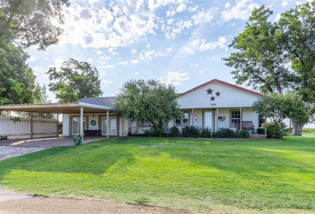 a view of a house with a yard and sitting area
