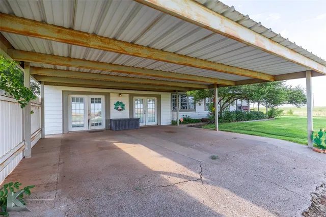 a view of a house with backyard and porch
