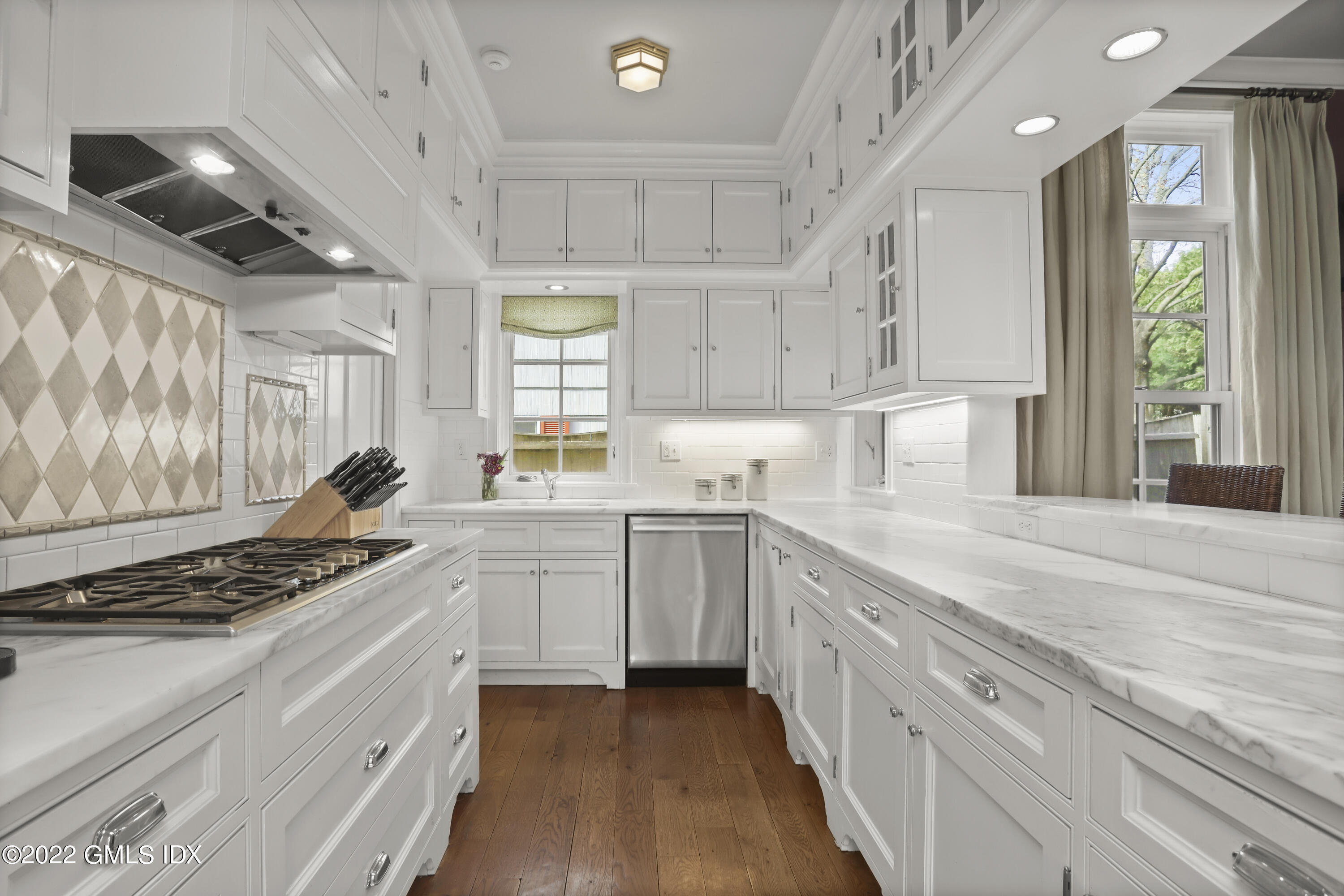 22 Glen Road Greenwich, CT 06830 - Photo 12 of 30 a kitchen with stainless steel appliances kitchen island granite countertop a stove and a sink