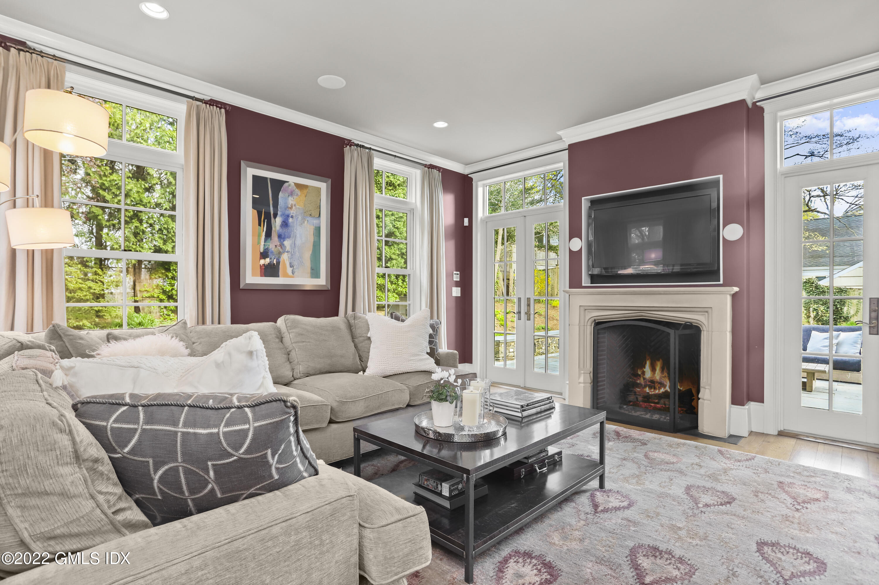 22 Glen Road Greenwich, CT 06830 - Photo 14 of 30 a living room with furniture a flat screen tv and a fireplace