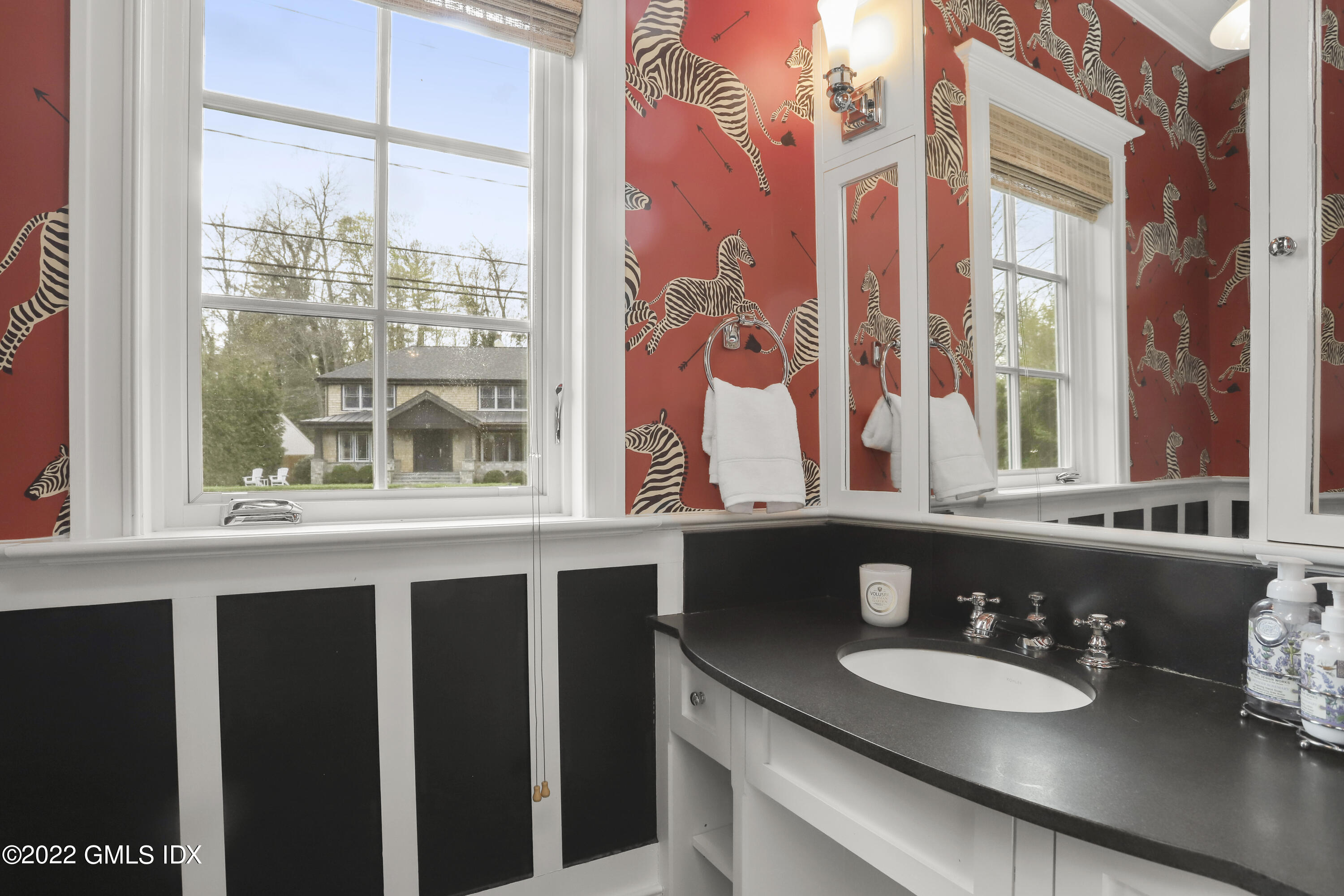 22 Glen Road Greenwich, CT 06830 - Photo 17 of 30 a bathroom with a granite countertop sink and a large mirror next to a window