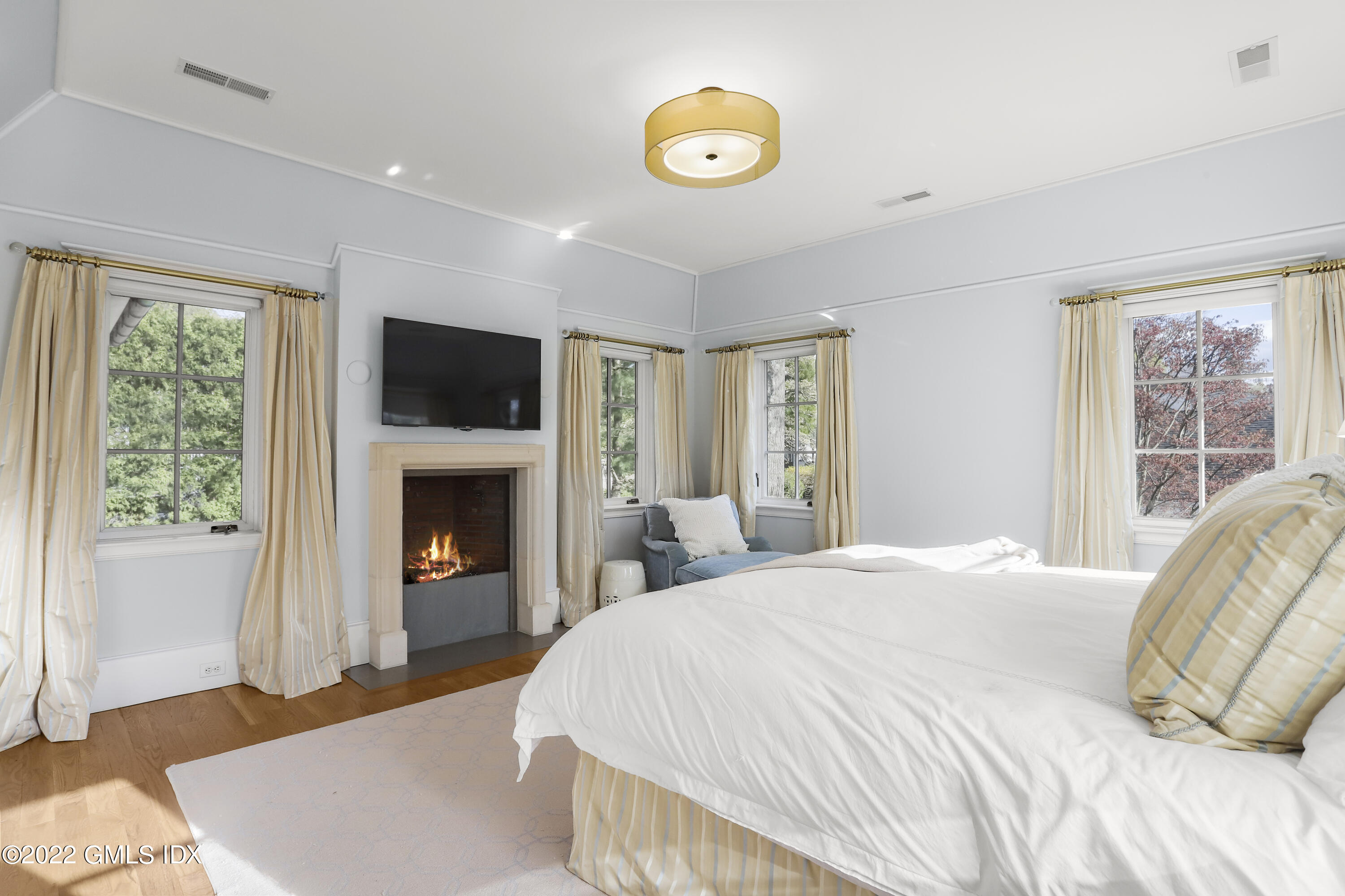 22 Glen Road Greenwich, CT 06830 - Photo 19 of 30 a bedroom with a bed and a fireplace
