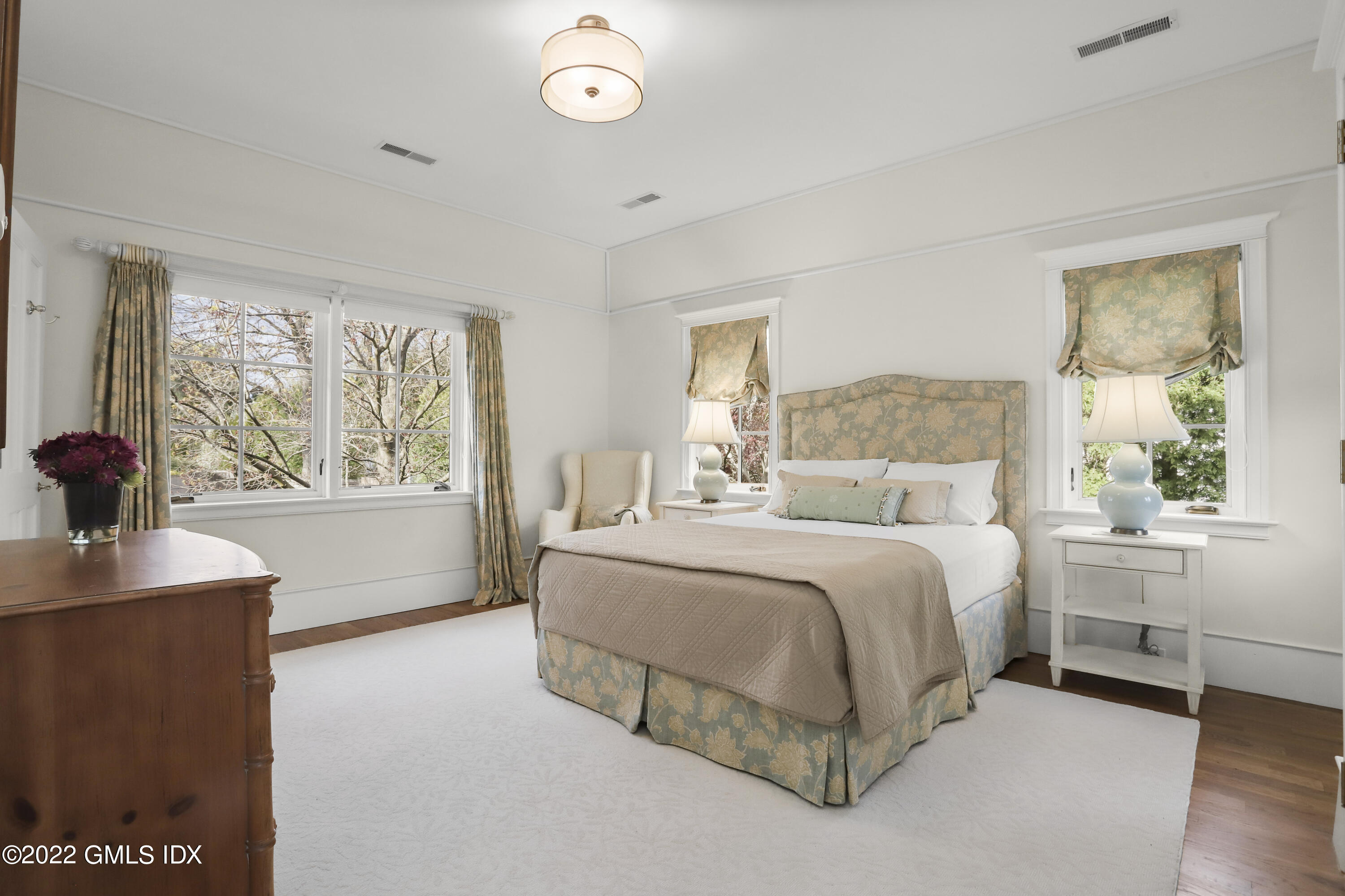 22 Glen Road Greenwich, CT 06830 - Photo 21 of 30 a spacious bedroom with a large bed and a window